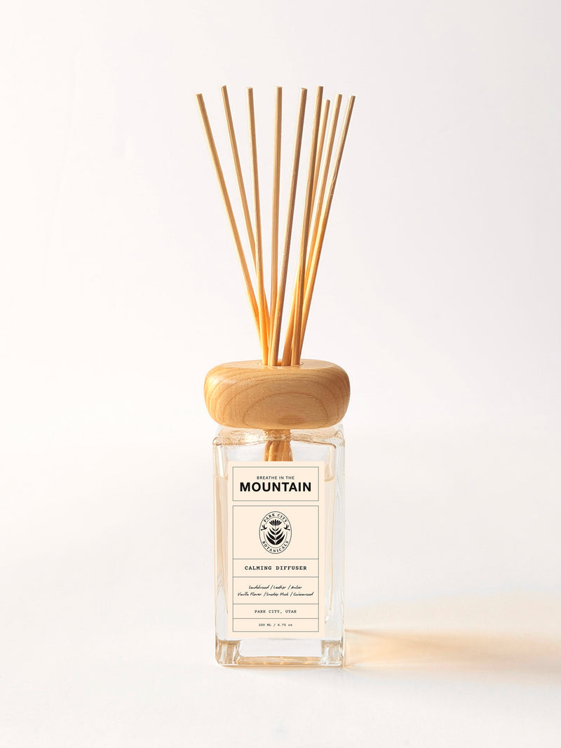 Diffuser with wooden sticks and a label on a white background
