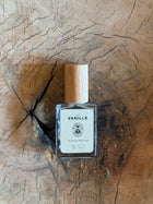 Perfume bottle labeled 'Vanille' on a wooden surface