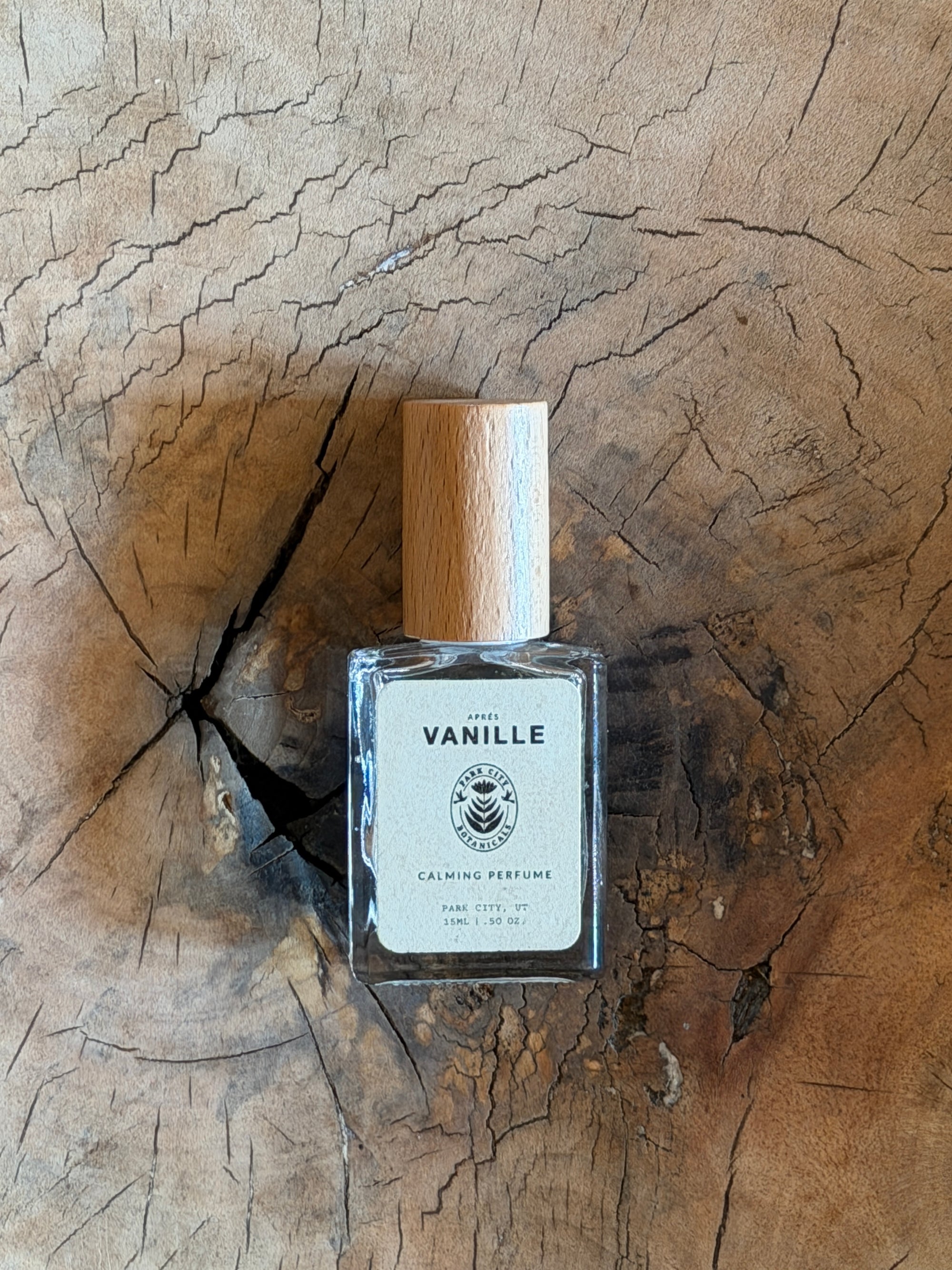 Perfume bottle labeled 'Vanille' on a wooden surface
