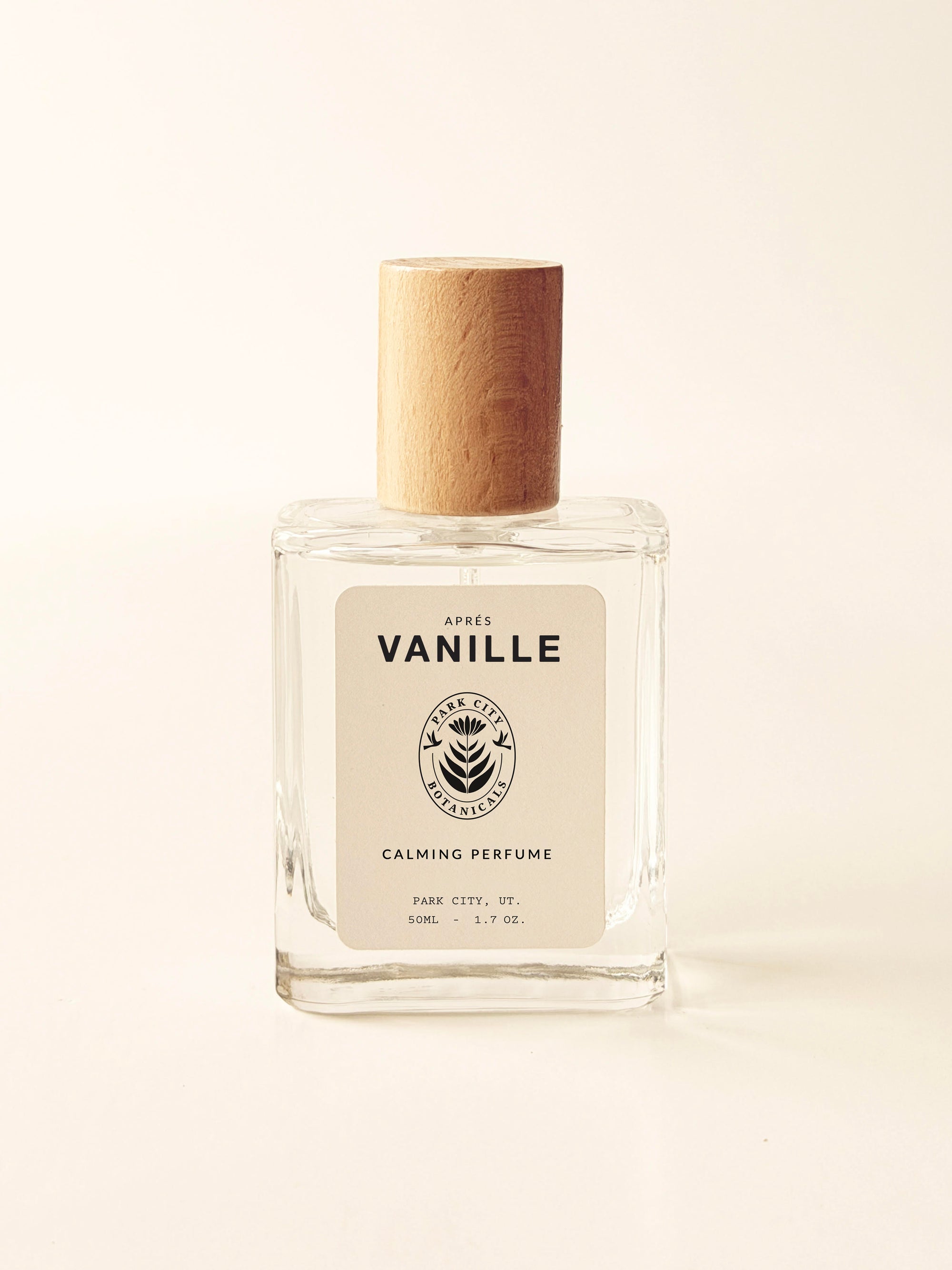 Perfume bottle labeled 'Breathe in the Forest' on a beige background